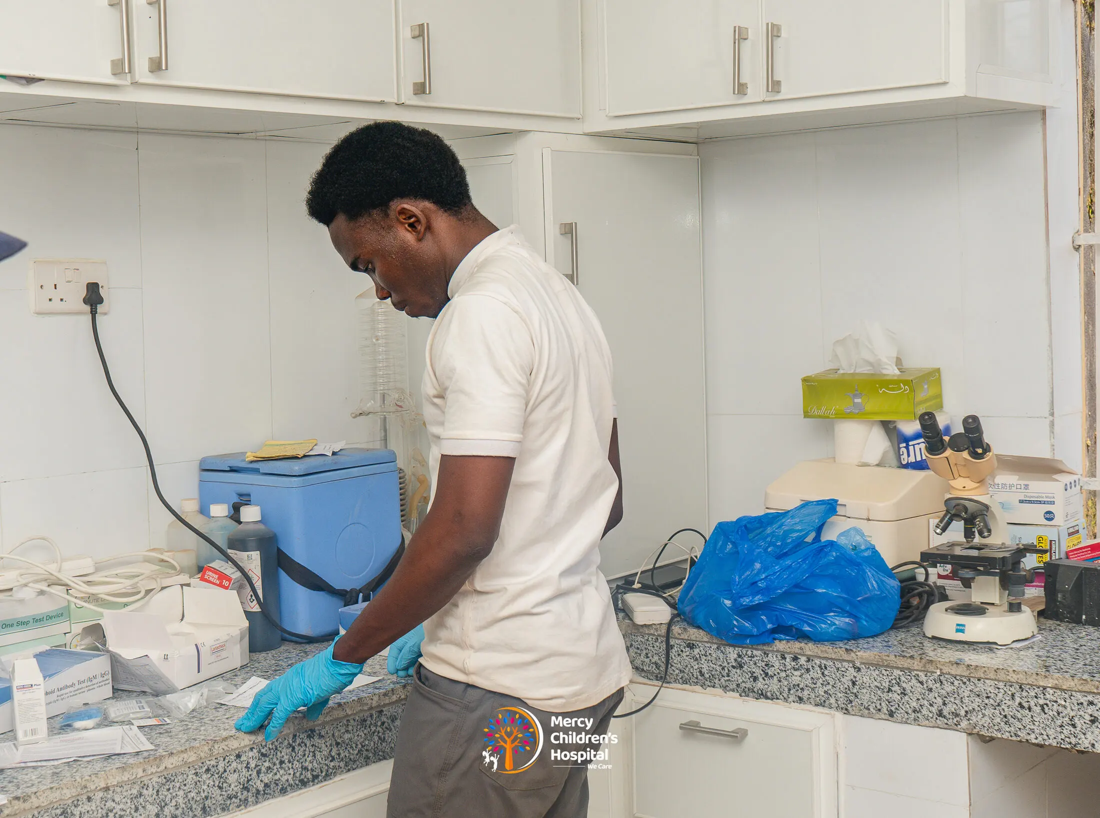 A technician working at the laboratory bench