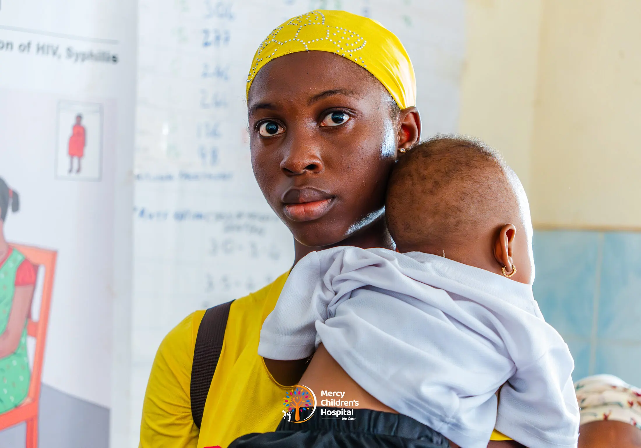 A mother carrying her baby at the clinic