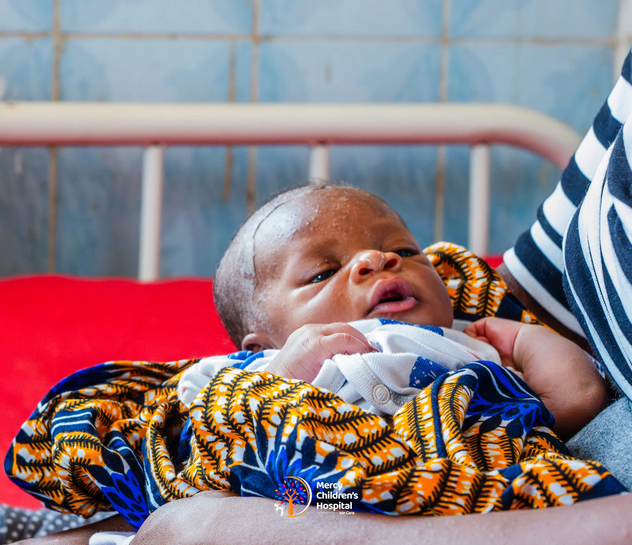 A newborn baby wrapped in patterned cloth