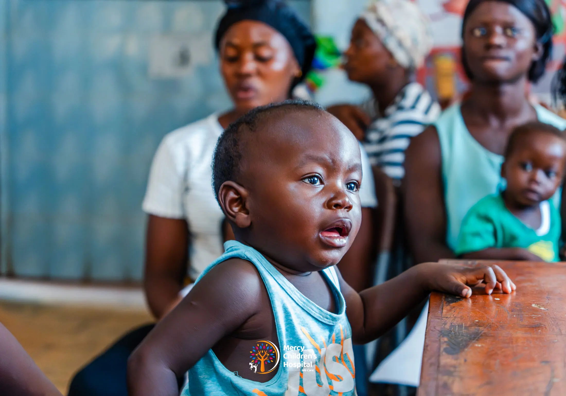 A toddler at a clinic desk during a growth check