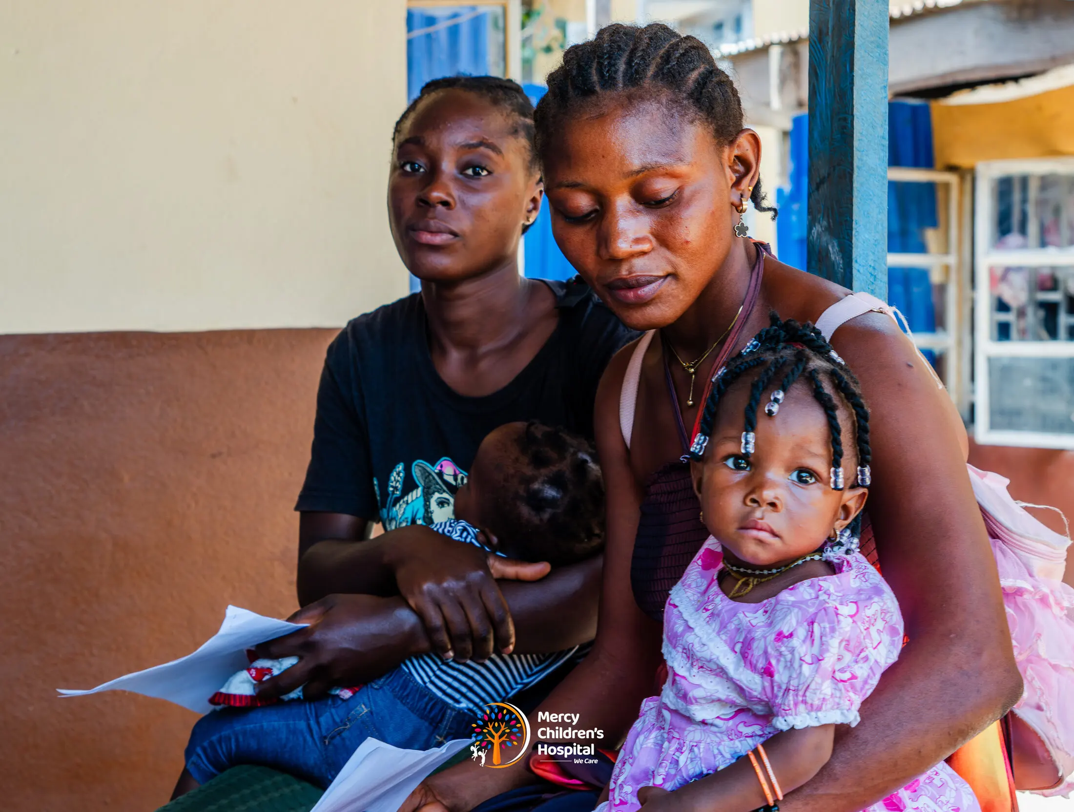 Mothers waiting with their children to be seen